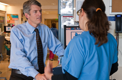 CTSI director, S. Claiborne Johnston, MD, PhD, speaks to a colleague at UCSF Med
