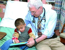 Paul Harmatz, MD, with young patient, Amro.