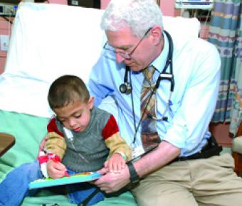 Paul Harmatz, MD, with young patient, Amro.